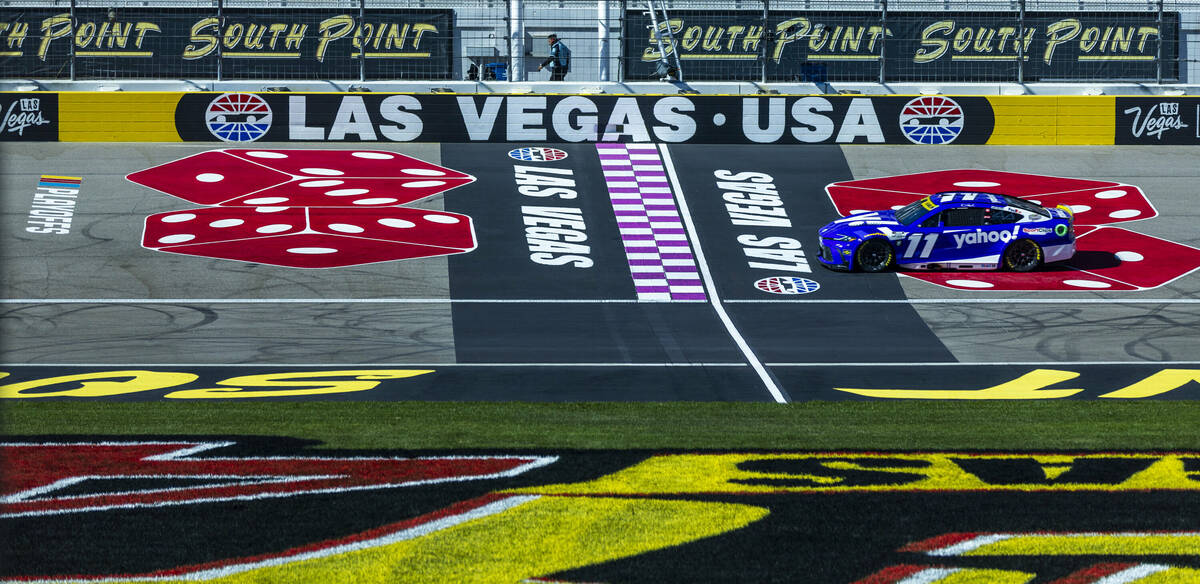 Denny Hamlin (11) passes the start/finish line during the NASCAR Cup Series practice session fo ...