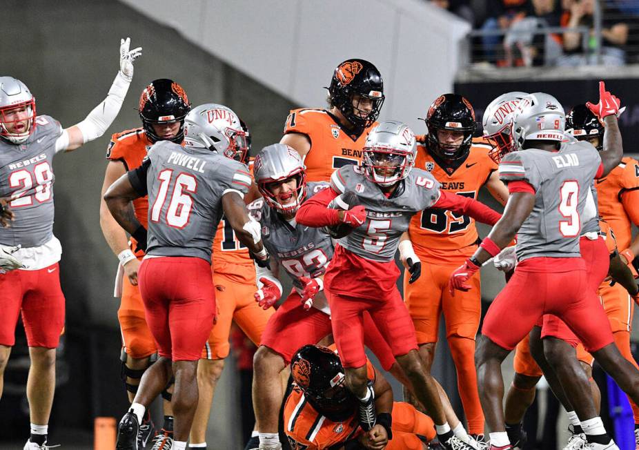 UNLV teammates celebrate as defensive back Cameron Oliver (5) recovers Oregon State's fumble du ...