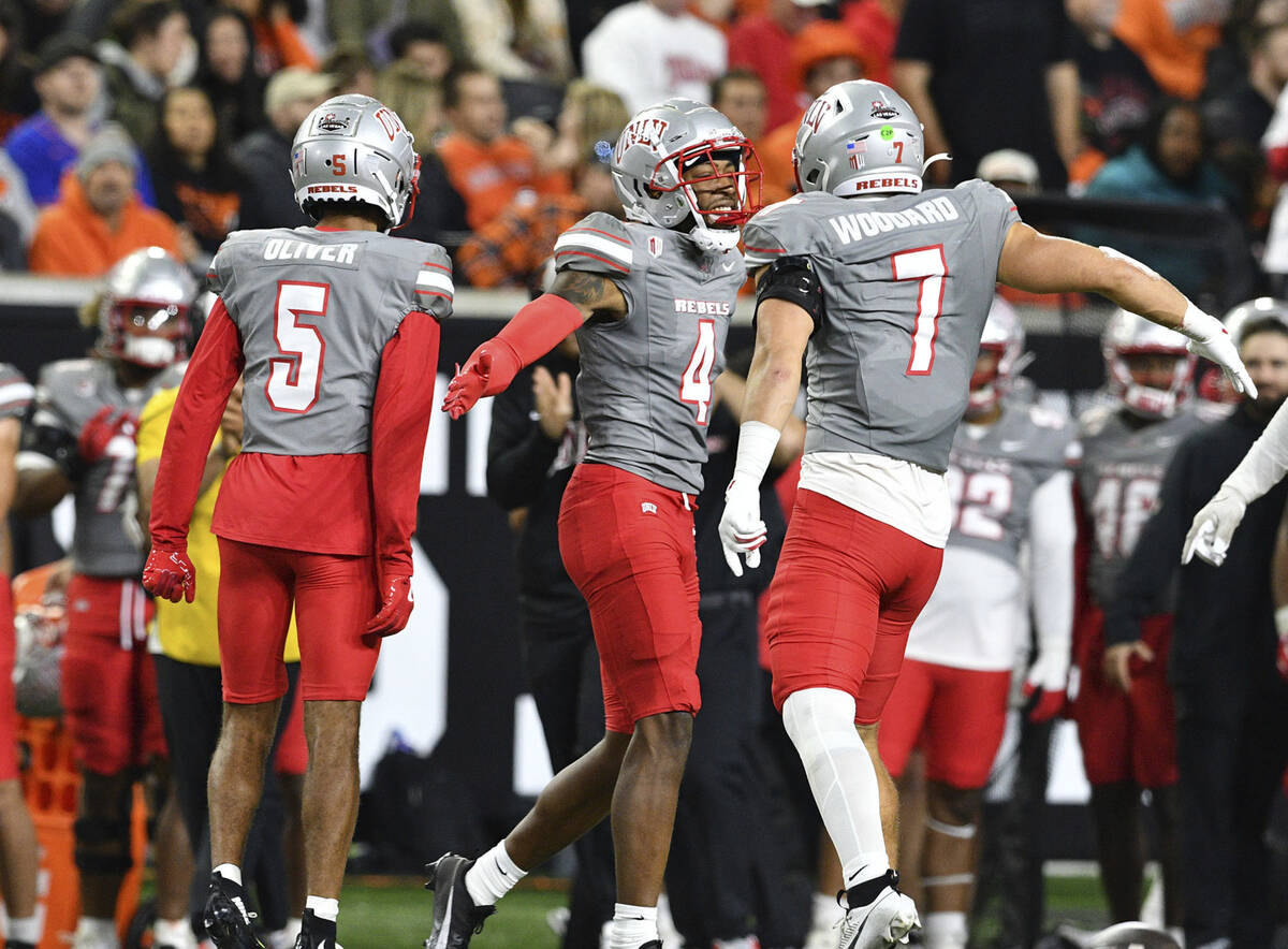 UNLV defensive backs Cameron Oliver (5), Malik Chavis (4) and linebacker Jackson Woodard (7) ce ...