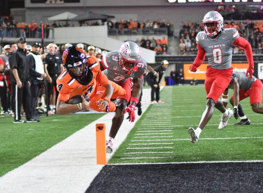 UNLV defensive back Jett Elad (9) pushes Oregon State quarterback Gevani McCoy (4) out of bound ...