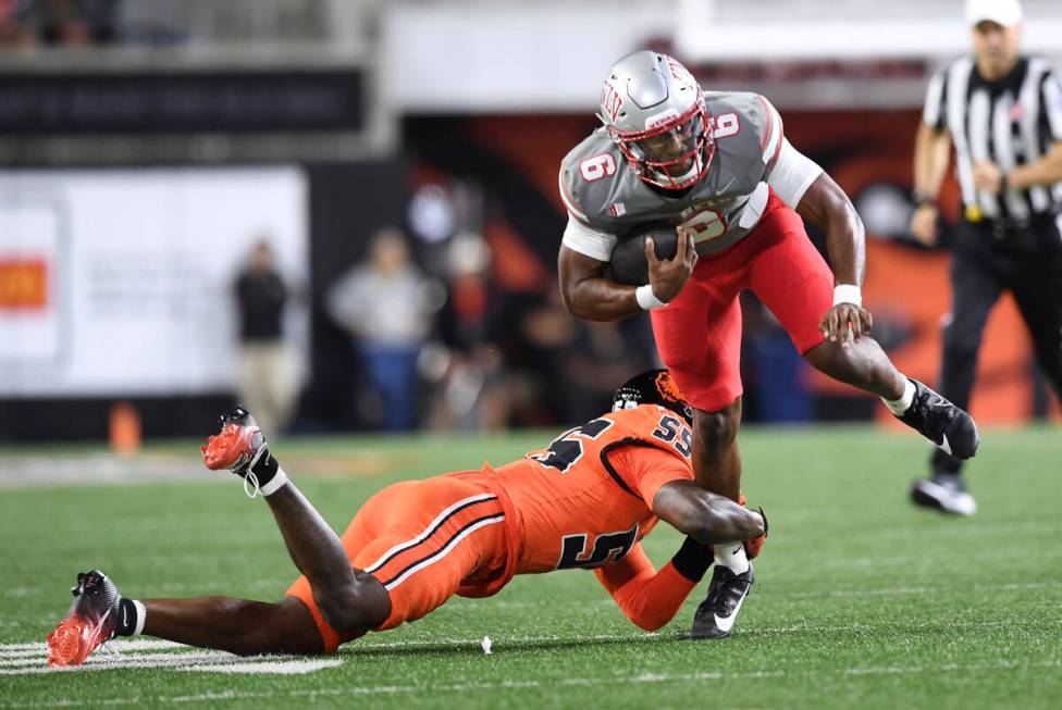 Oregon State linebacker Dexter Foster (55) tackles UNLV quarterback Hajj-Malik Williams (6) dur ...