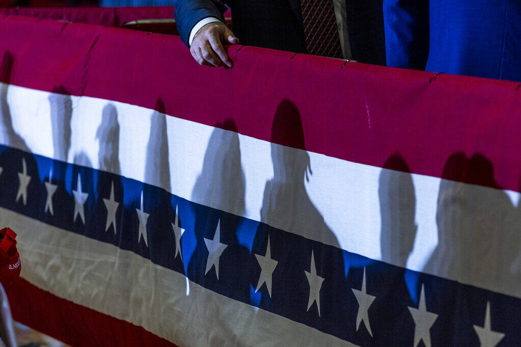 Supporter's shadows are cast on some bunting in the gym before Ohio Senator JD Vance delivers r ...