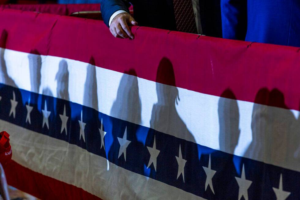 Supporter's shadows are cast on some bunting in the gym before Ohio Senator JD Vance delivers r ...