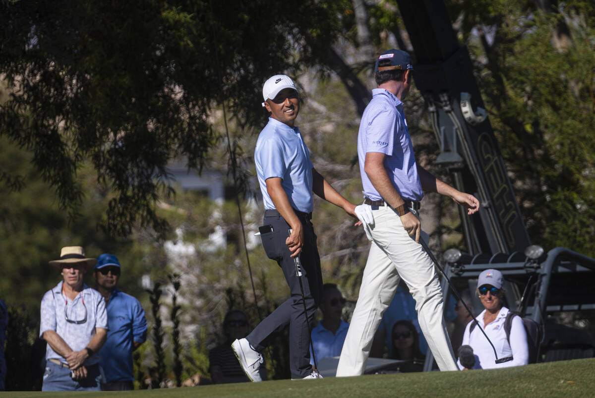 Doug Ghim, left, chats with J.T. Poston at the 10th hole during the final round of the Shriner ...