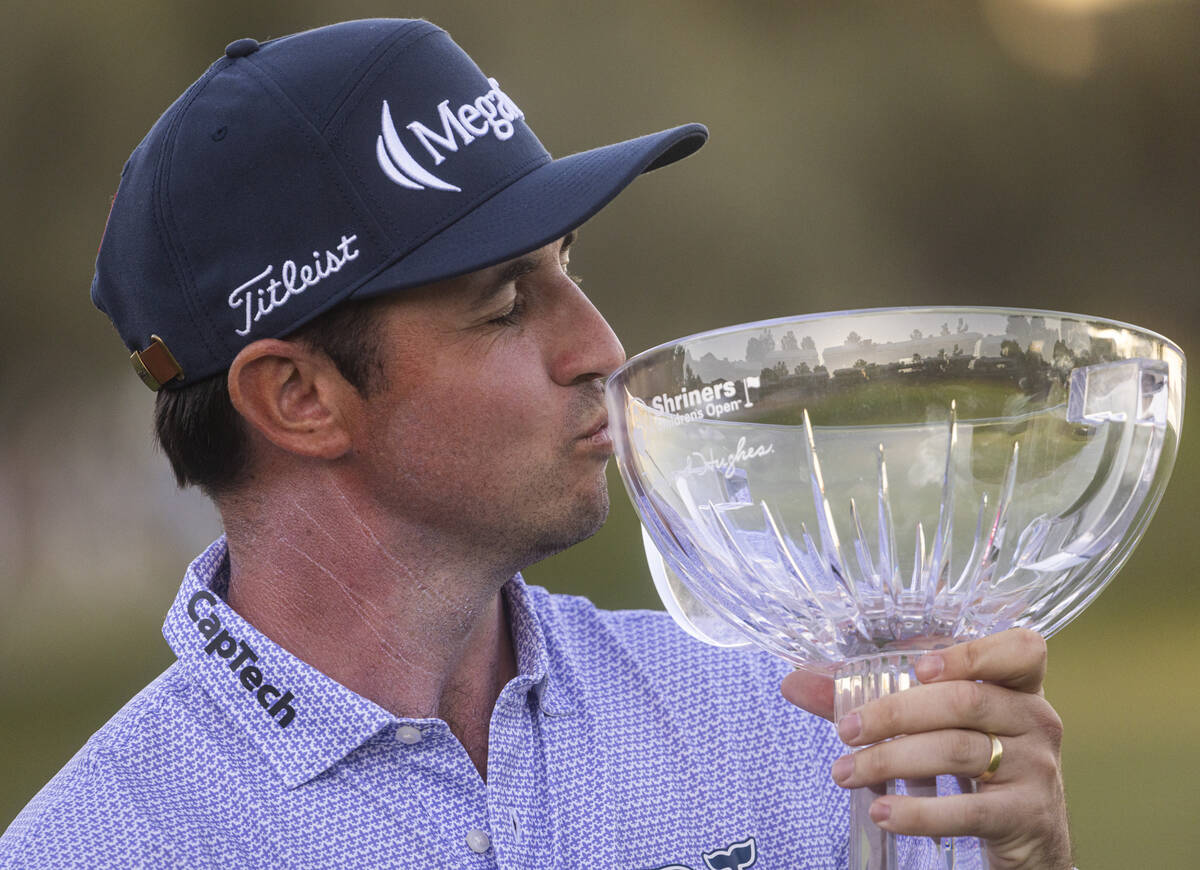 J.T. Poston kisses the trophy after winning the Shriners Children’s Open at TPC Summerli ...