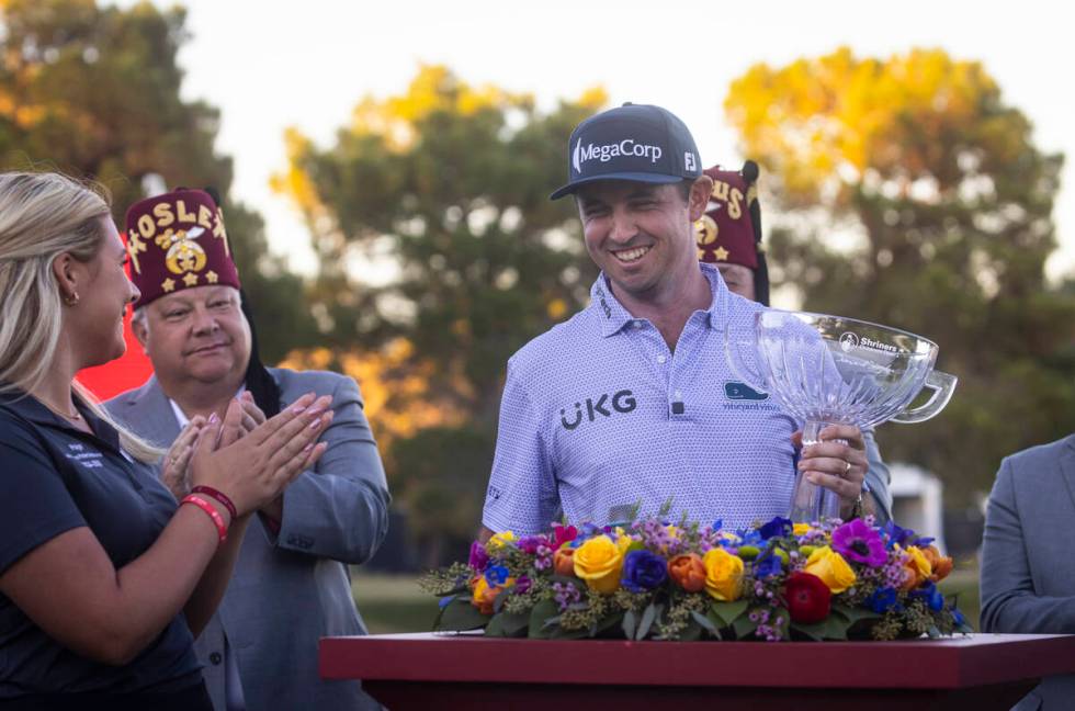 J.T. Poston holds the trophy after winning the Shriners Children’s Open at TPC Summerlin ...