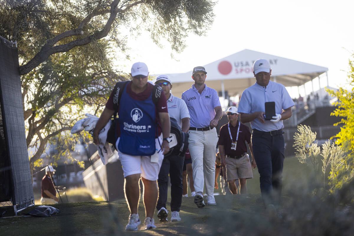 J.T. Poston, center right, walks to tee off at the 18th hole during the final round of the Shri ...