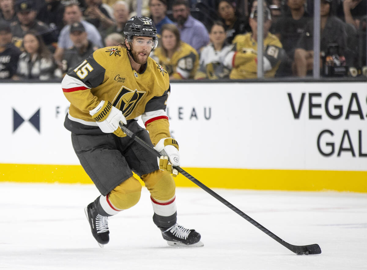 Golden Knights defenseman Noah Hanifin (15) skates with the puck during the NHL hockey game aga ...