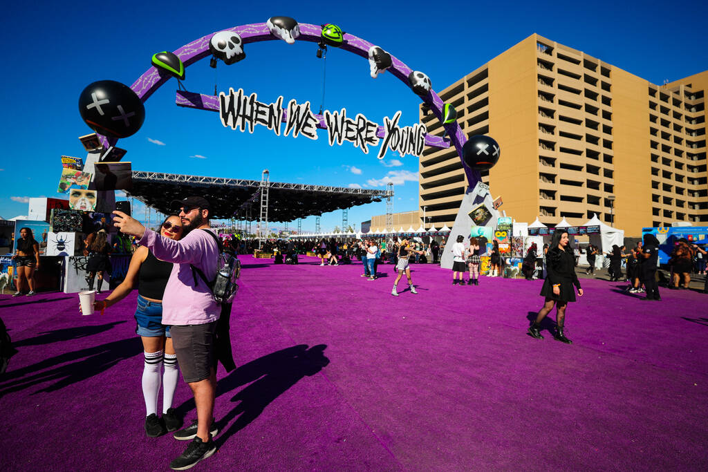 Festival attendees take photographs during the When We Were Young music festival at the Las Veg ...