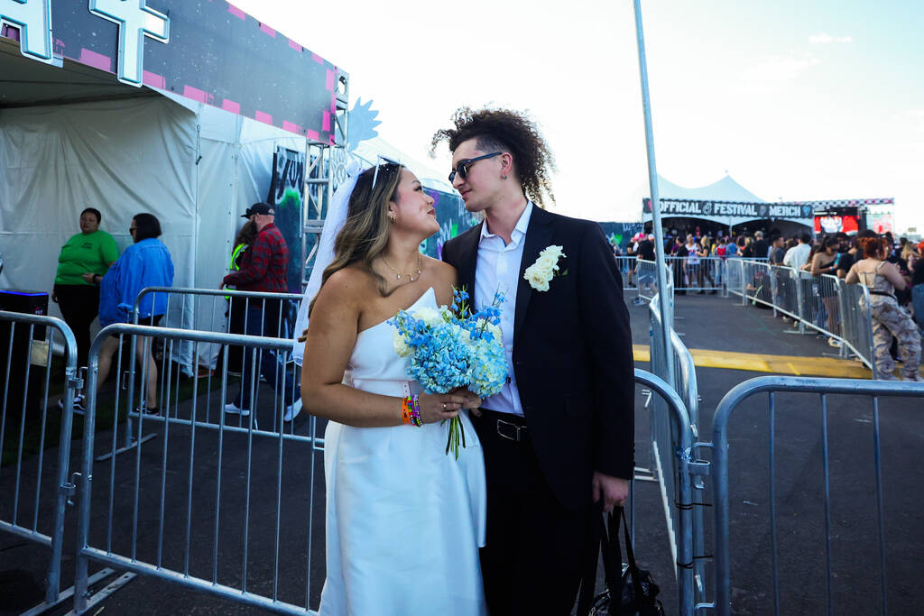 Emily Powers, left, looks to her husband, Jeff Powers, both of Michigan, after getting married ...