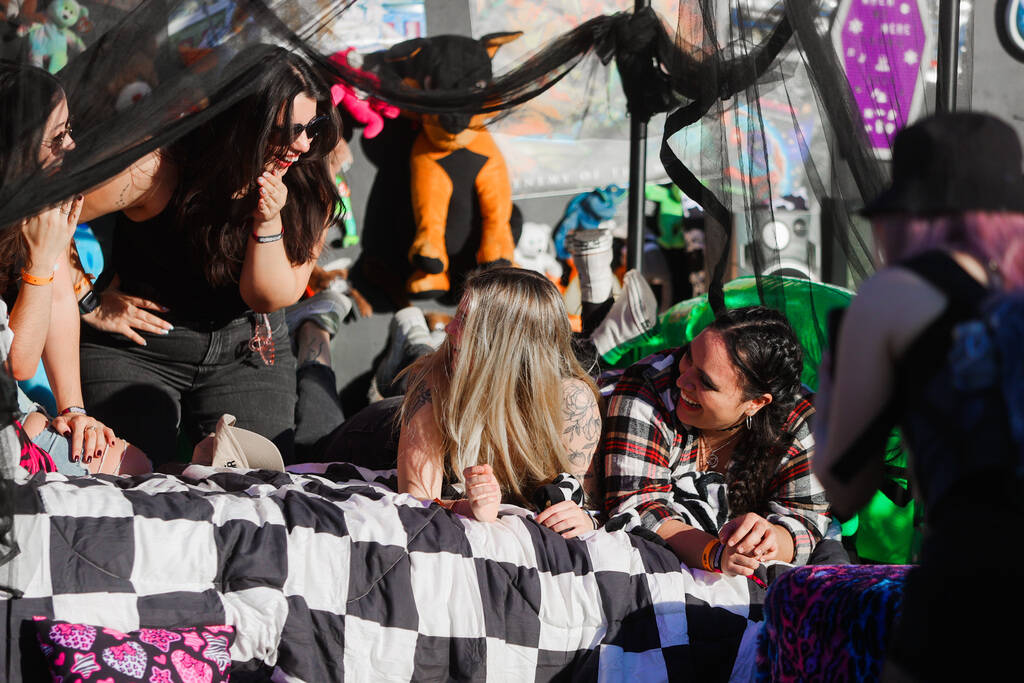 Festival attendees pose inside of a fake bedroom during the When We Were young music festival a ...