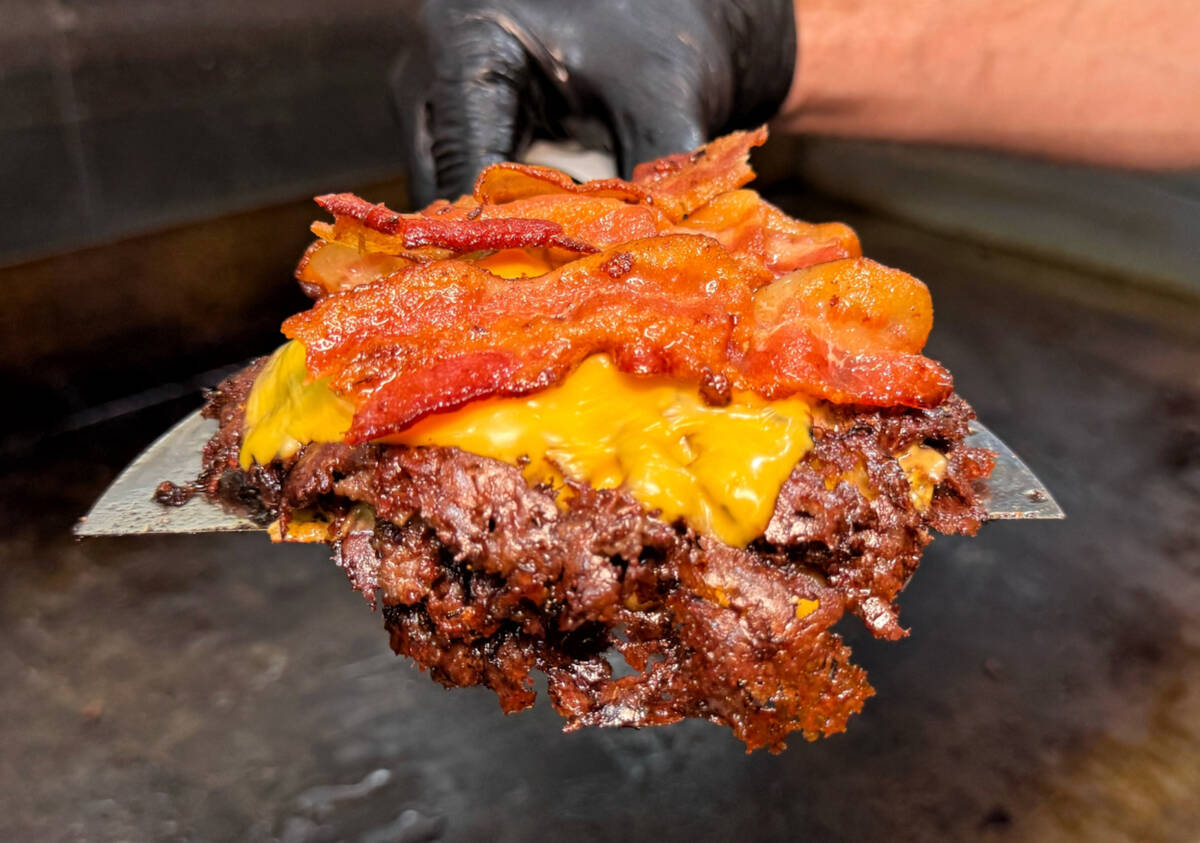 A smash burger patty with American cheese and bacon from With Love, Always, a new restaurant as ...