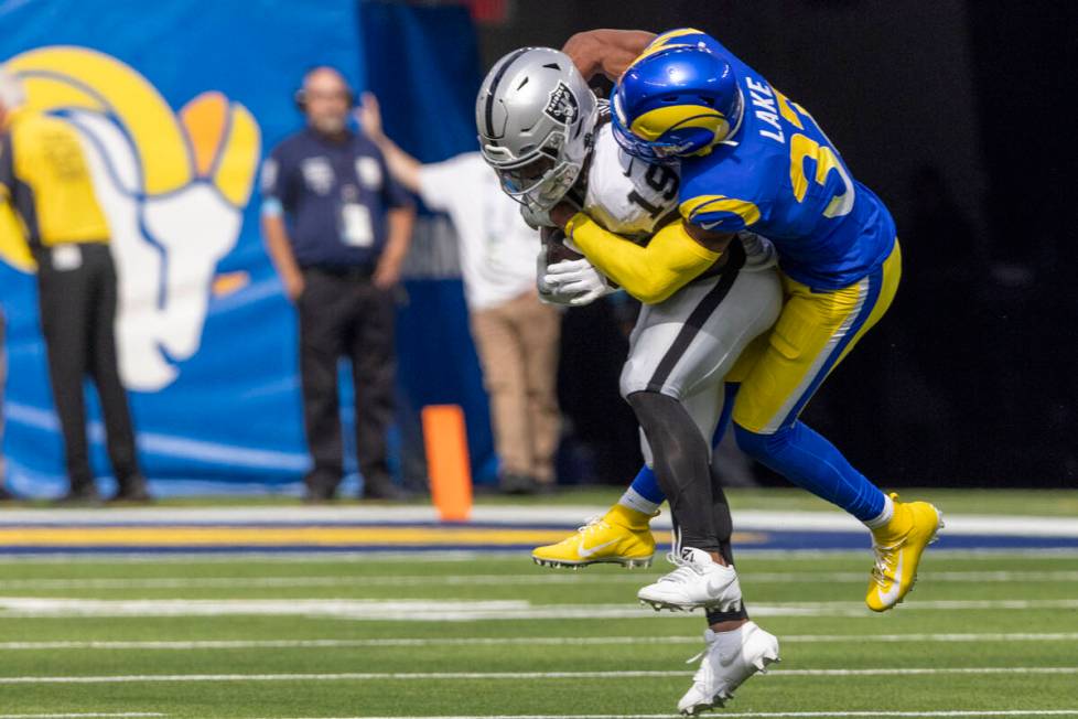 Raiders wide receiver DJ Turner (19) is tackled by Los Angeles Rams safety Quentin Lake (37) du ...