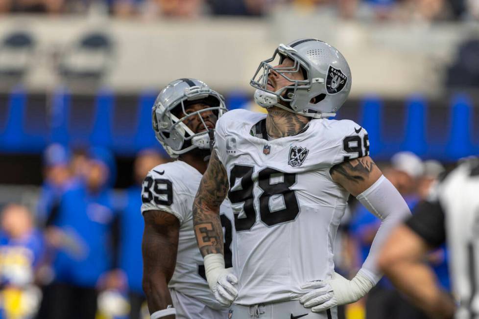 Raiders defensive end Maxx Crosby (98) looks to a replay monitor after being called for roughin ...