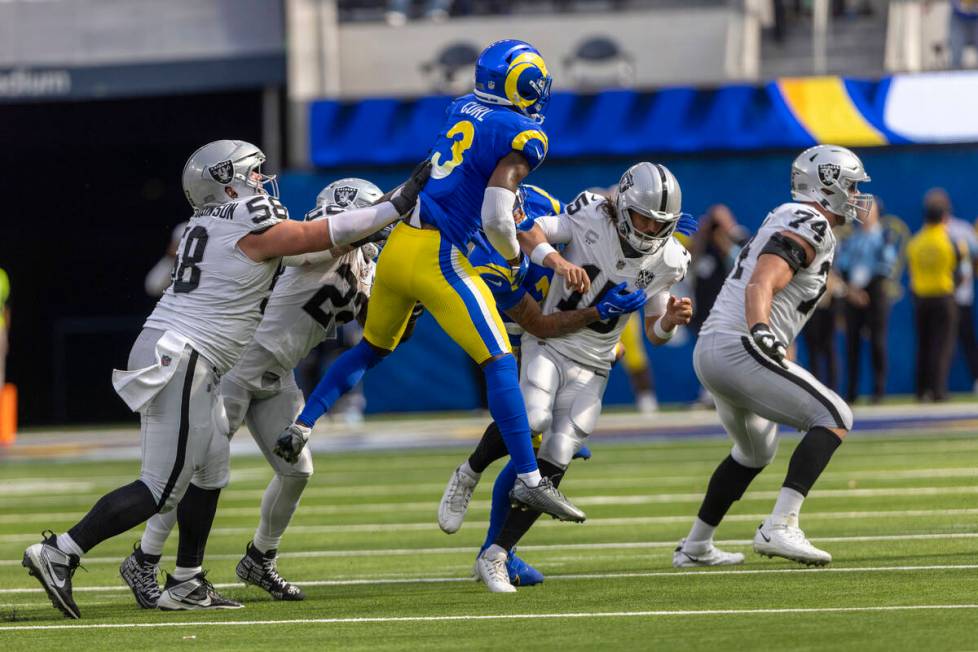 Raiders quarterback Gardner Minshew (15) fumbles the football as he is sacked by Los Angeles Ra ...