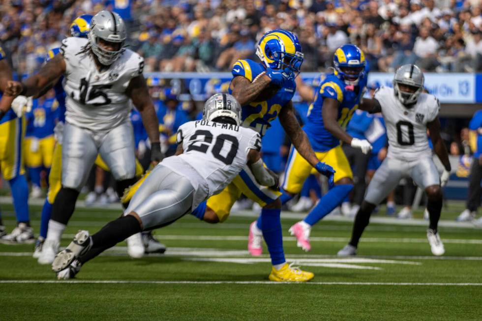 Los Angeles Rams running back Kyren Williams (23) escapes a tackle by Raiders safety Isaiah Pol ...