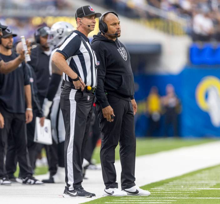 Raiders head coach Antonio Pierce looks on as a referee explains a penalty during the second ha ...