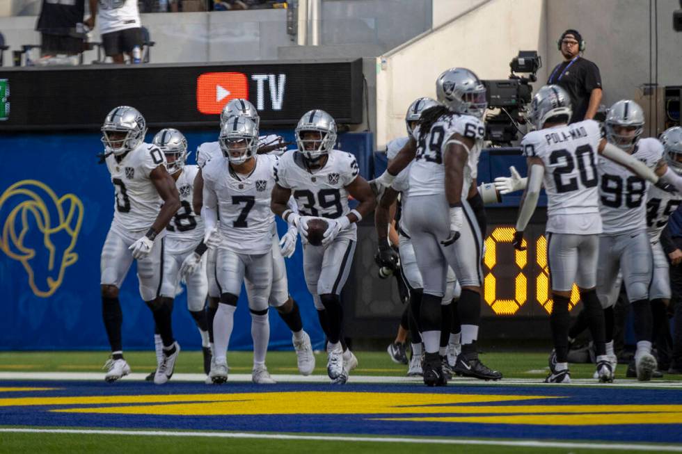 Raiders cornerback Nate Hobbs (39) celebrates his interception of Los Angeles Rams quarterback ...