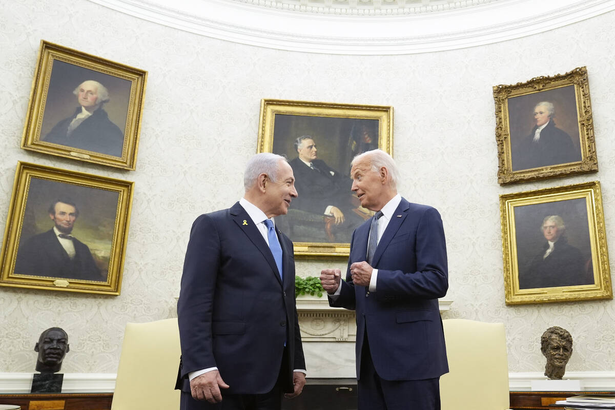 FILE - President Joe Biden, right, talks with Israeli Prime Minister Benjamin Netanyahu, left, ...