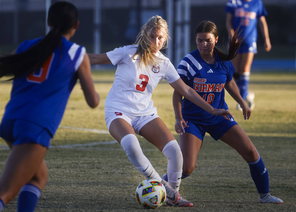 Coronado midfielder Alexandra Milano (3) kicks the ball under pressure from Bishop Gorman midfi ...