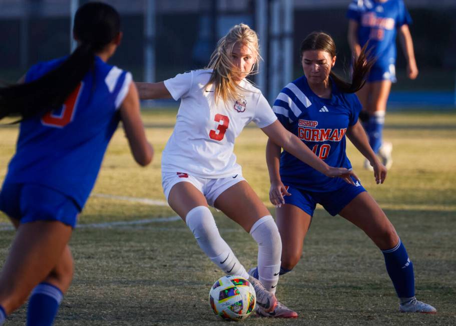 Coronado midfielder Alexandra Milano (3) kicks the ball under pressure from Bishop Gorman midfi ...