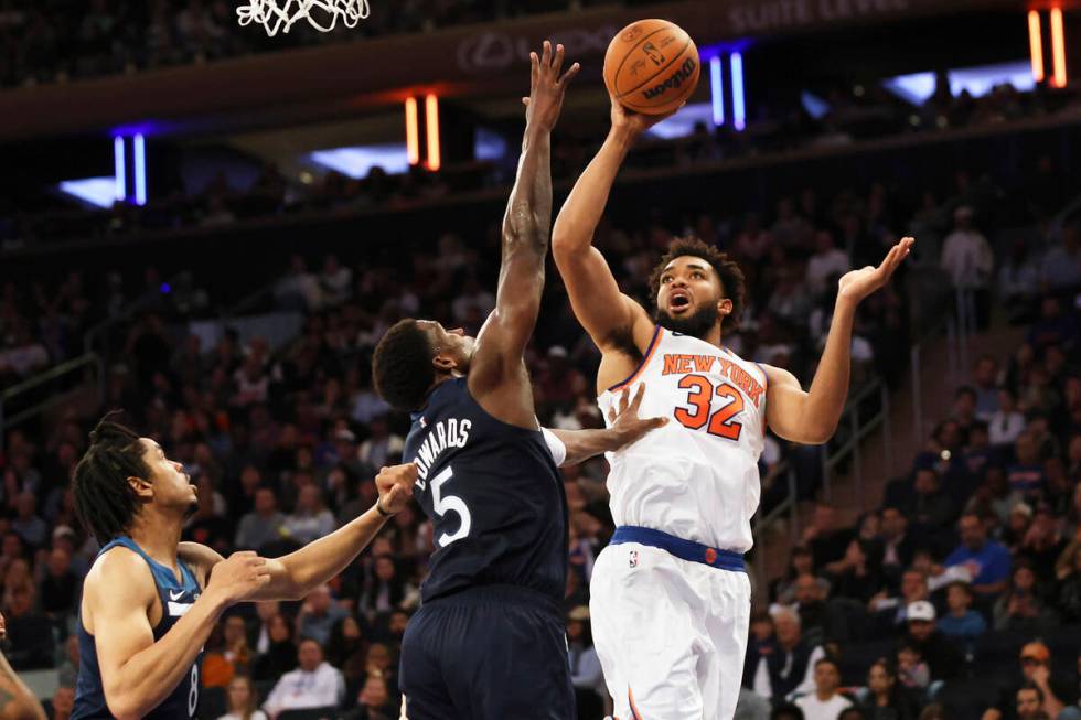 New York Knicks' Karl-Anthony Towns (32) looks to shoot over Minnesota Timberwolves guard Antho ...