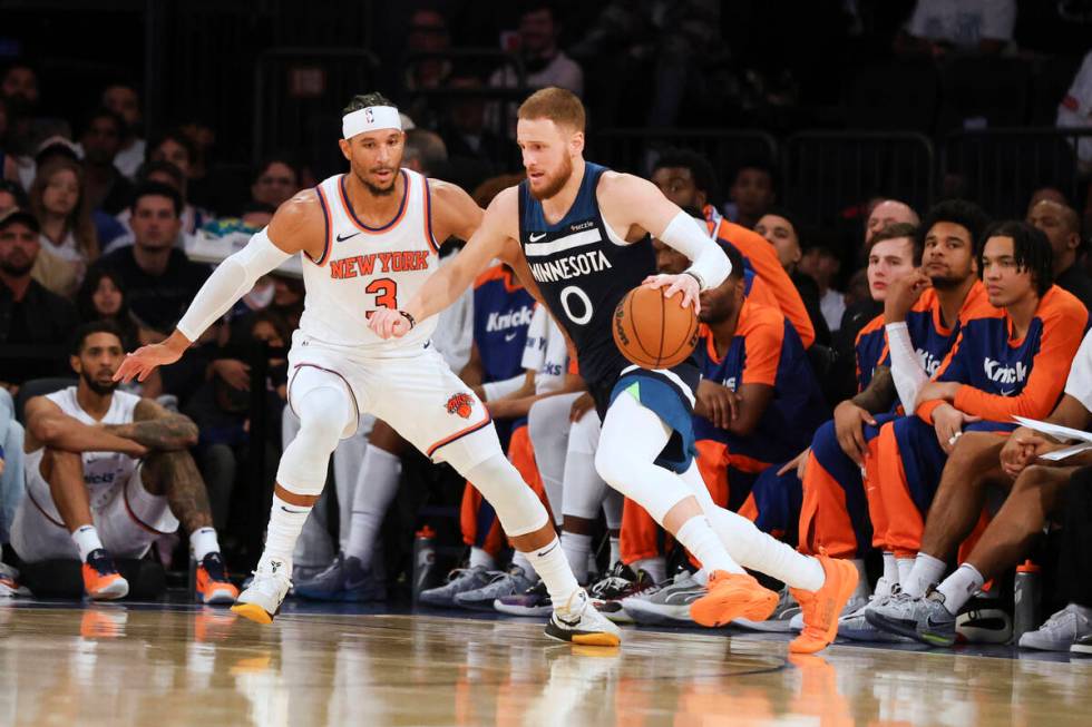 Minnesota Timberwolves guard Donte DiVincenzo is defended by New York Knicks' Josh Hart during ...