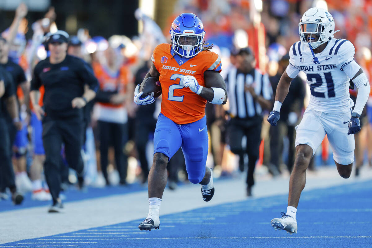 Boise State running back Ashton Jeanty (2) runs away from Utah State safety Malik McConico (21) ...