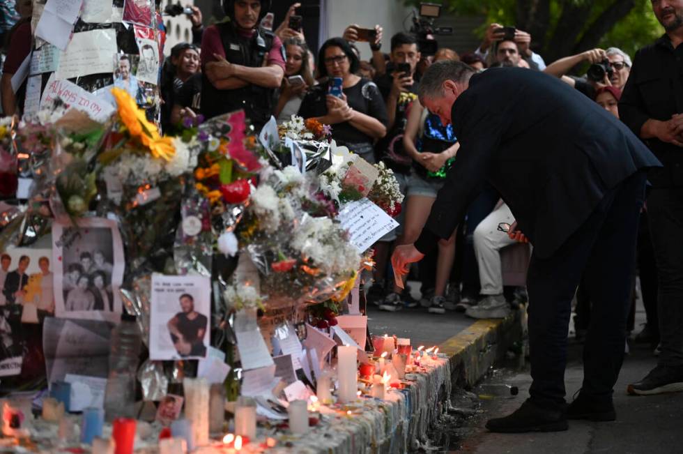 Geoff Payne, right, father of former One Direction member Liam Payne, visits a makeshift altar ...