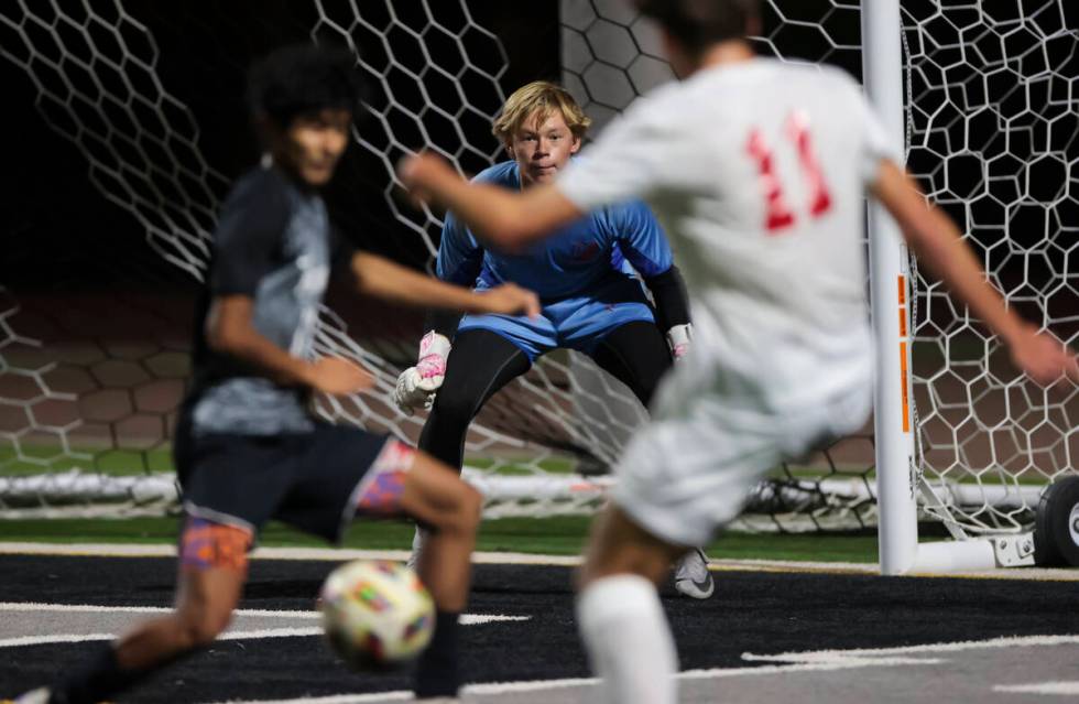 Palo Verde goalkeeper Landon Blanchard keeps his eye on the ball as Coronado's Gavin Flickinger ...