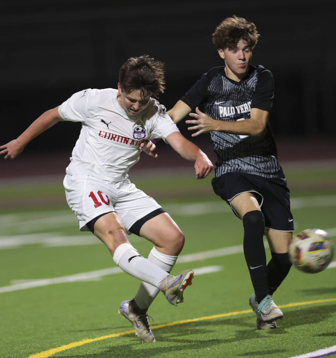 Coronado midfielder Aiden Sena (10) kicks the ball past Palo Verde defender Jaxon Law (2) durin ...