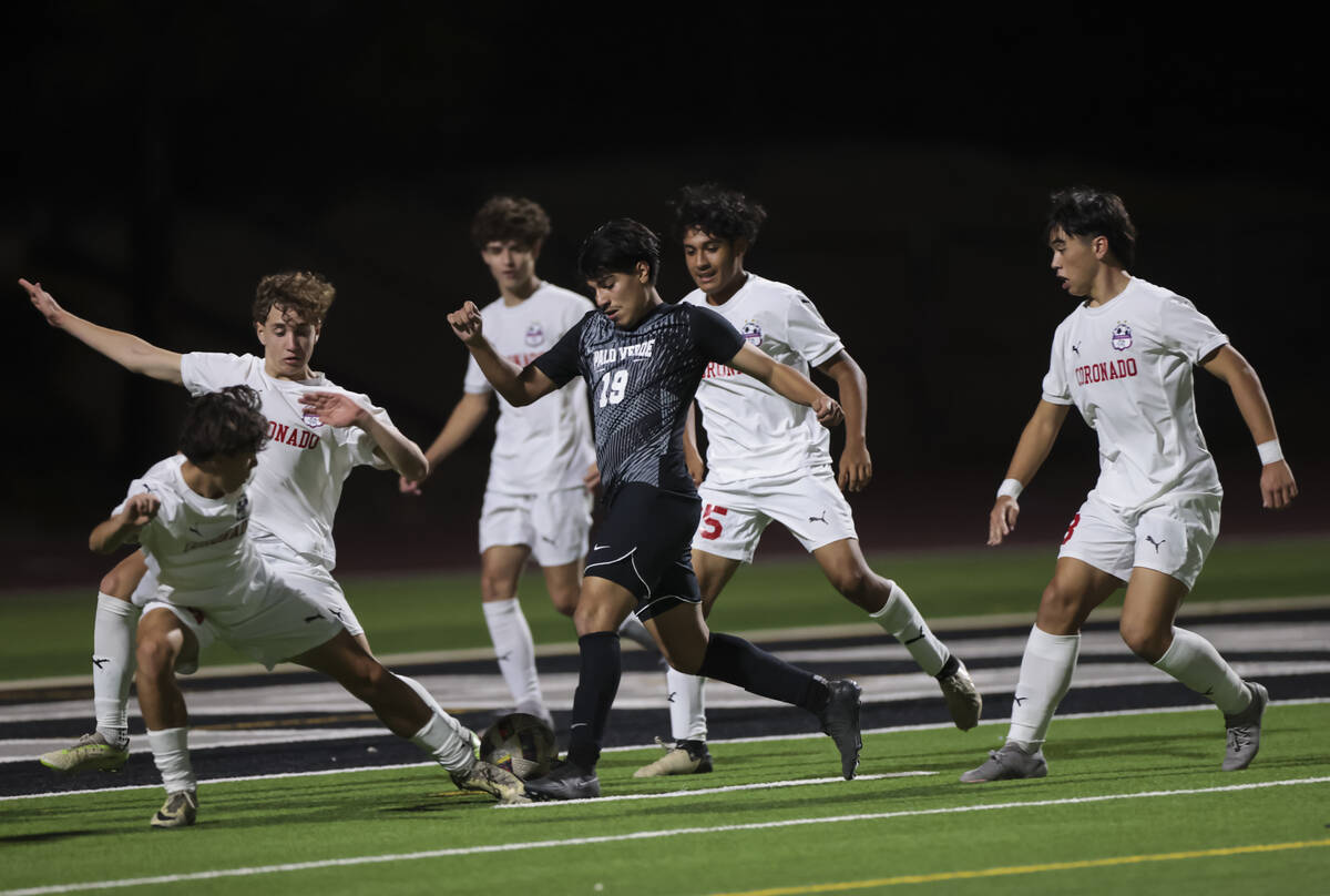 Palo Verde’s Eder Aguila (19) tries to get through a phalanx of Coronado defenders durin ...