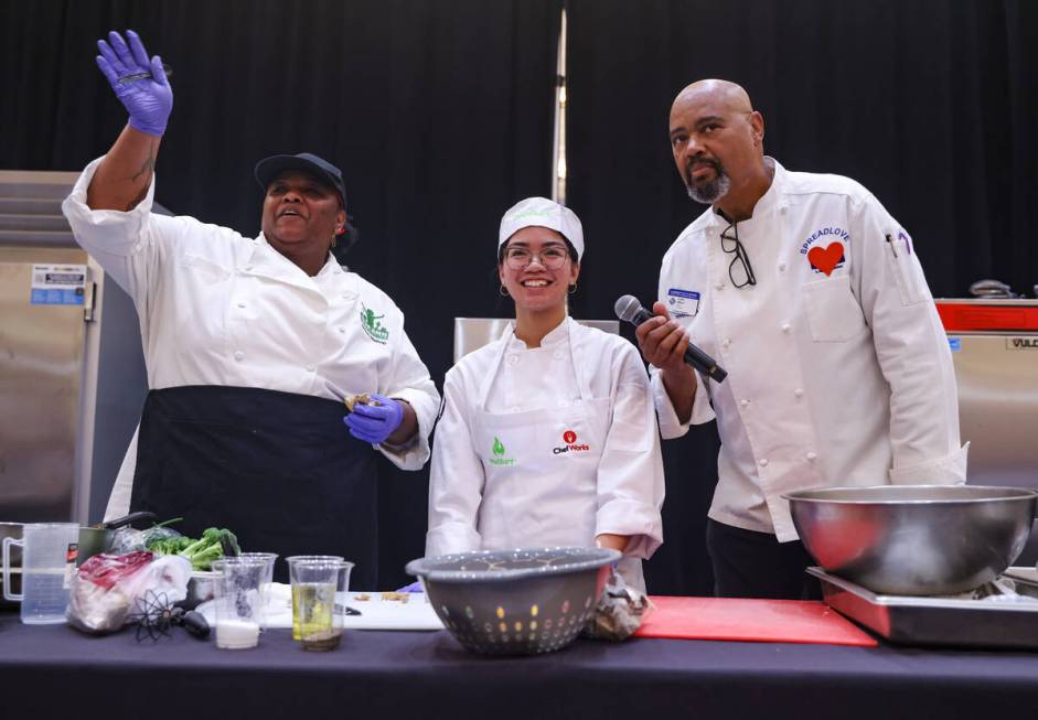 Nicole Patague, 16, from Silverado High School, center, speaks with host and chef Curtis Aiken, ...