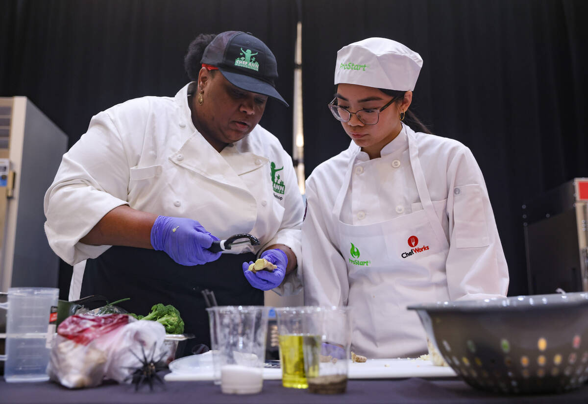 Nicole Patague, 16, from Silverado High School, gets help from Chef Janien Bishop as she compet ...