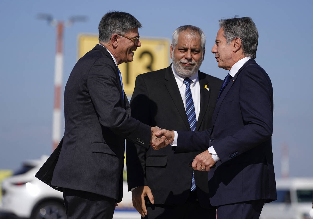 US Secretary of State Antony Blinken (R) is greeted by US Ambassador to Israel Jack Lew (L) and ...