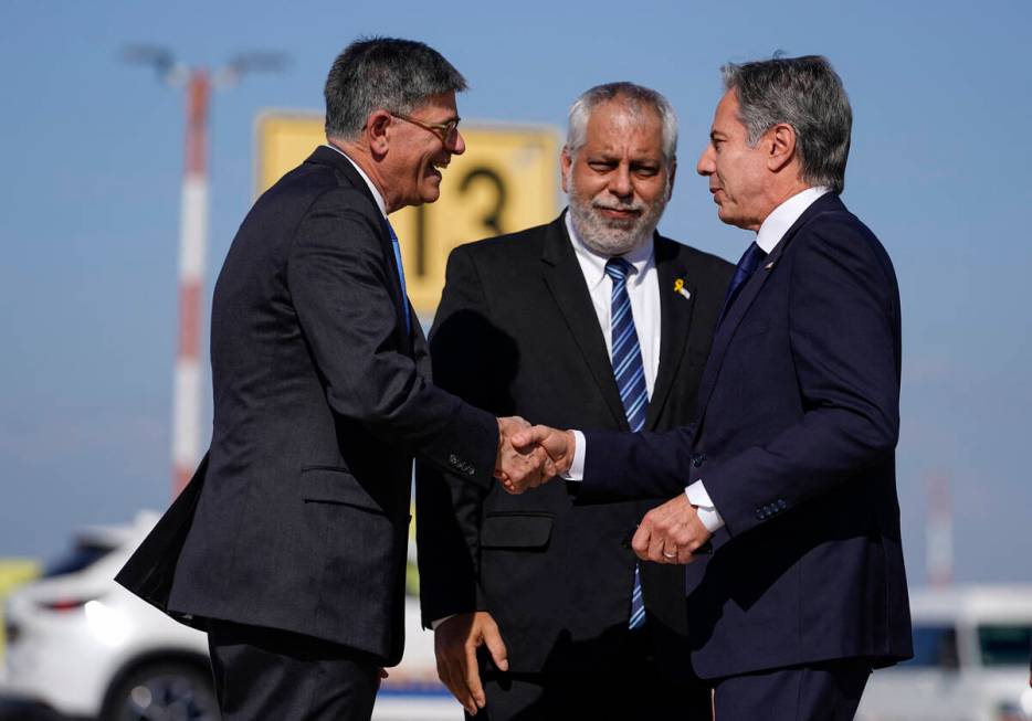 US Secretary of State Antony Blinken (R) is greeted by US Ambassador to Israel Jack Lew (L) and ...