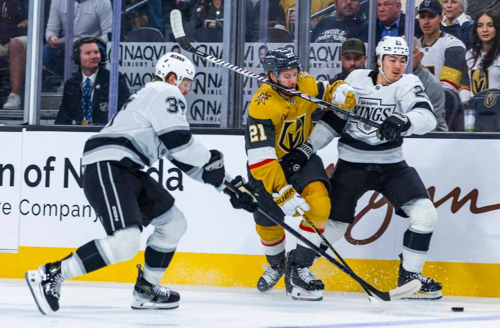 Golden Knights center Brett Howden (21) takes a stick to the face from Los Angeles Kings defens ...