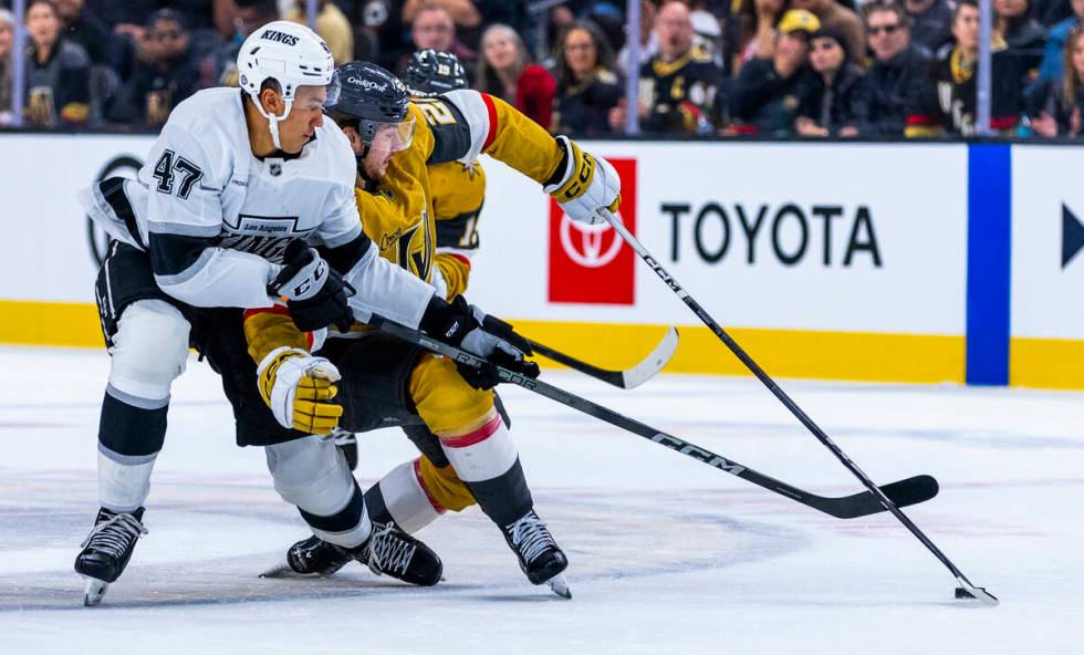 Golden Knights right wing Cole Schwindt (22) is tied up as Los Angeles Kings left wing Andre Le ...