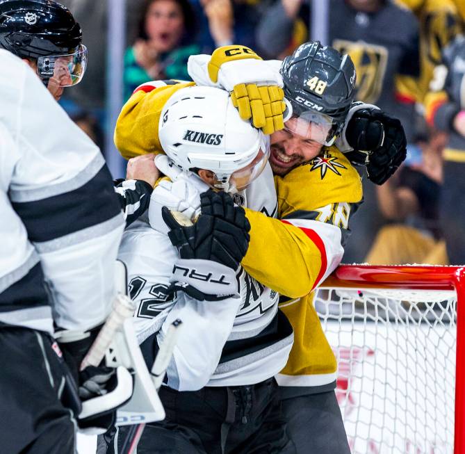 Los Angeles Kings left wing Trevor Moore (12) is wrapped up by Golden Knights center Tomas Hert ...