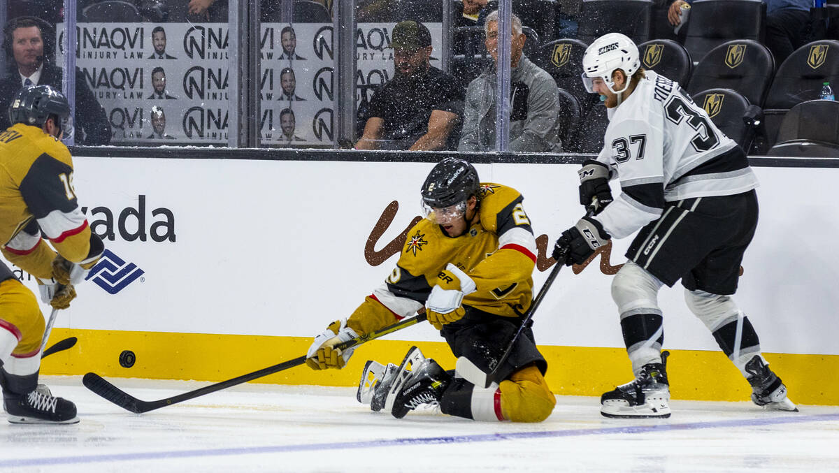 Golden Knights defenseman Zach Whitecloud (2) continues to track the puck from the ice with Los ...