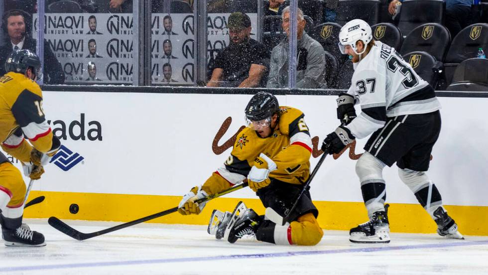 Golden Knights defenseman Zach Whitecloud (2) continues to track the puck from the ice with Los ...