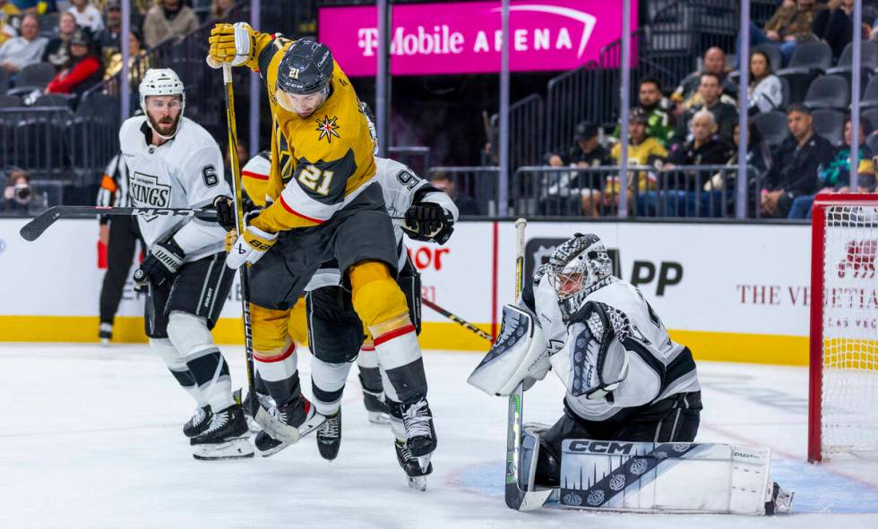 Golden Knights center Brett Howden (21) leaps to deflect a shot at Los Angeles Kings goaltender ...