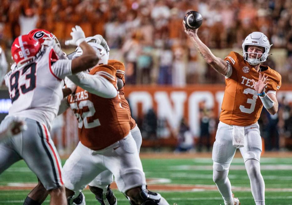 Texas quarterback Quinn Ewers (3) passes against Georgia during the second half of an NCAA coll ...