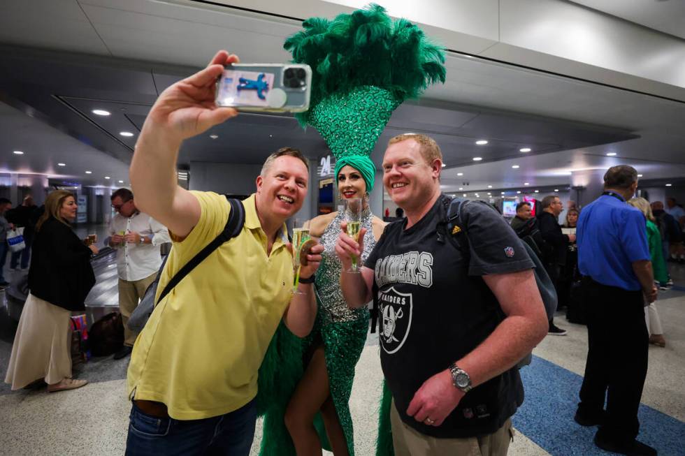 Garry Kelly, left, and Brian McNamara, right, take a selfie with a showgirl following Air Lingu ...