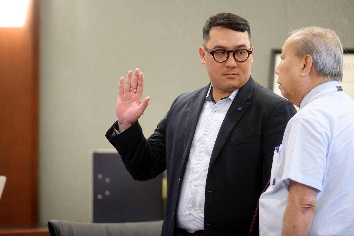 Witness Tuan Trinh, left, is sworn in with the help of interpreter Jimmy Tong Nguyen during the ...