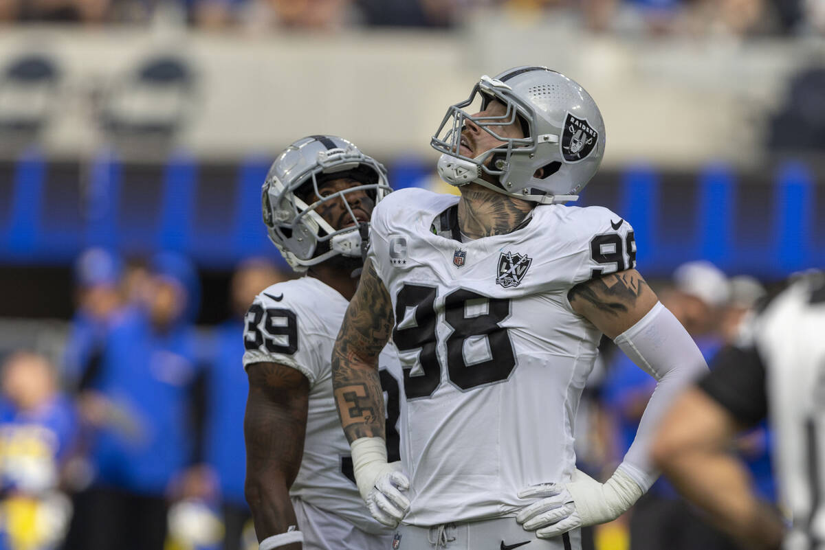 Raiders defensive end Maxx Crosby (98) looks to a replay monitor after being called for roughin ...