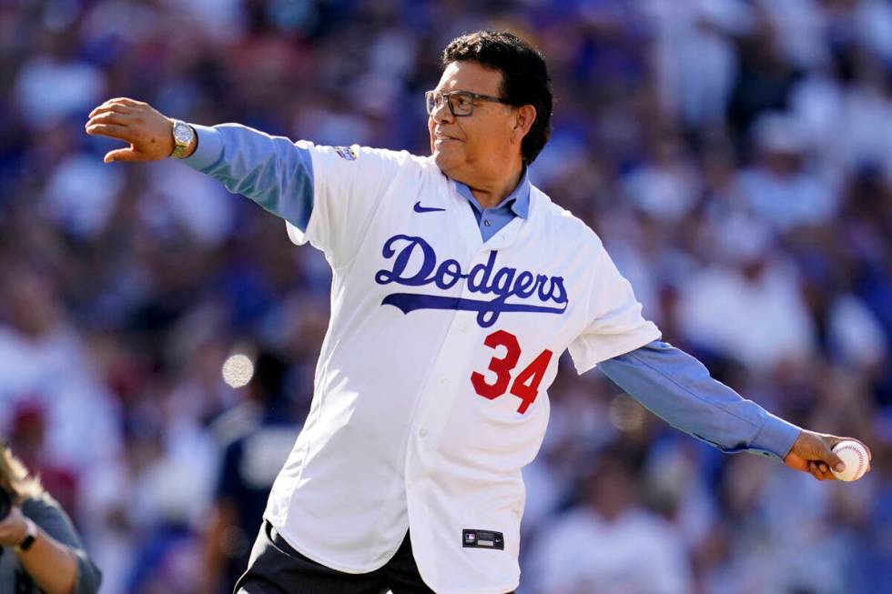 FILE - Former Los Angeles Dodgers pitcher Fernando Valenzuela throws the ceremonial first pitch ...