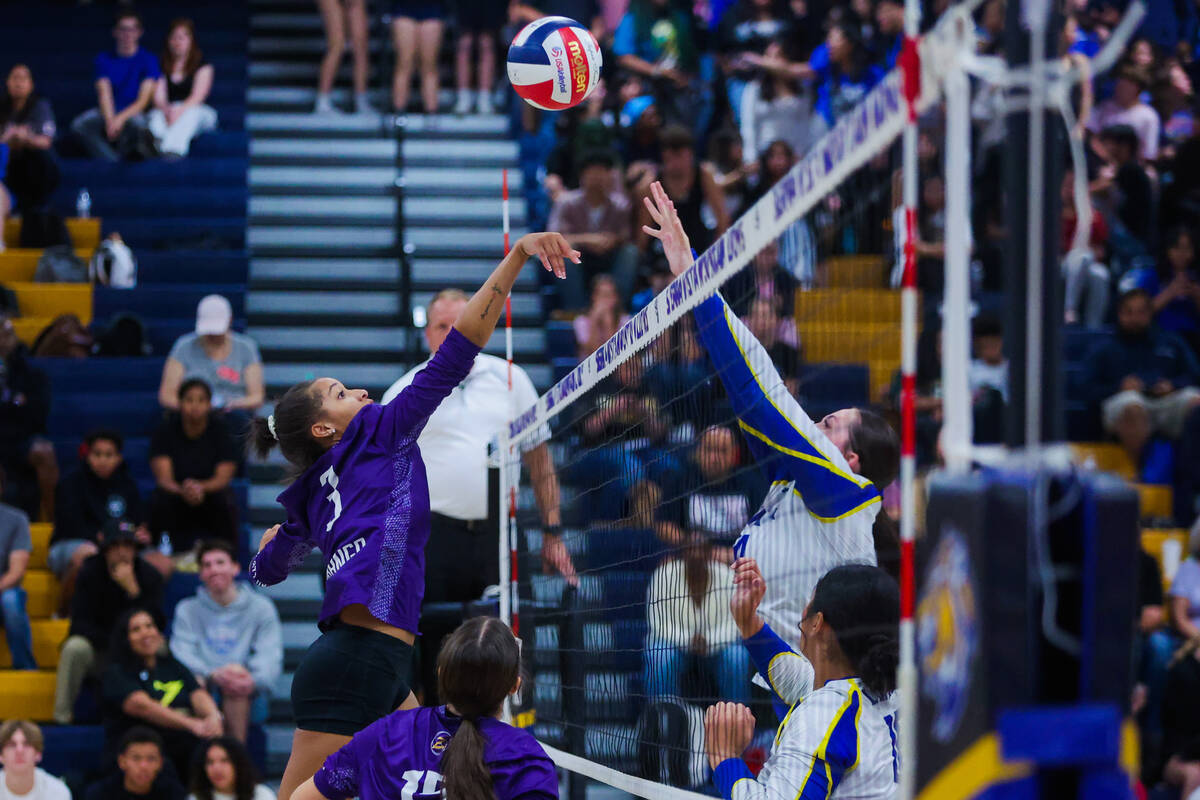 Durango middle blocker Alana Riddick (3) leaps to hit the ball back over the net during a volle ...