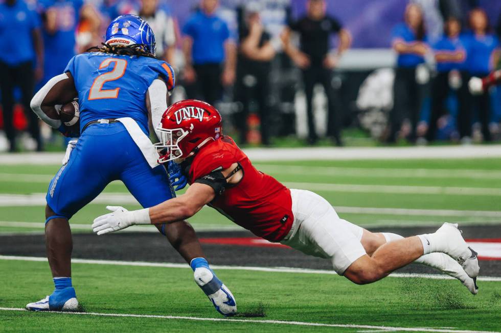 UNLV linebacker Jackson Woodard (7) jumps to keep Boise State running back Ashton Jeanty (2) fr ...