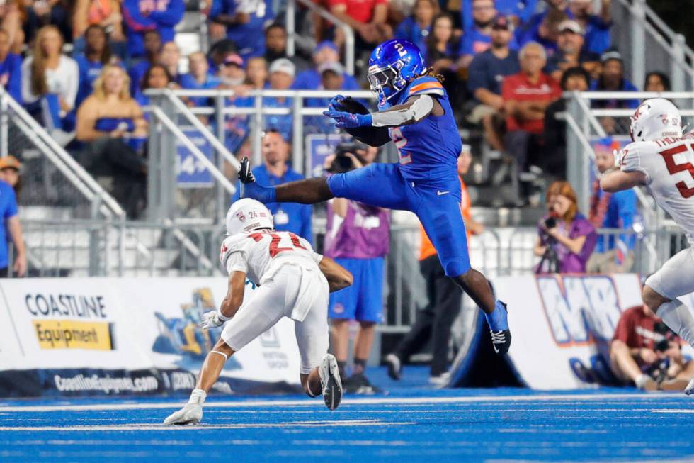 Boise State running back Ashton Jeanty (2) hurdles Washington State defensive back Ethan O'Conn ...